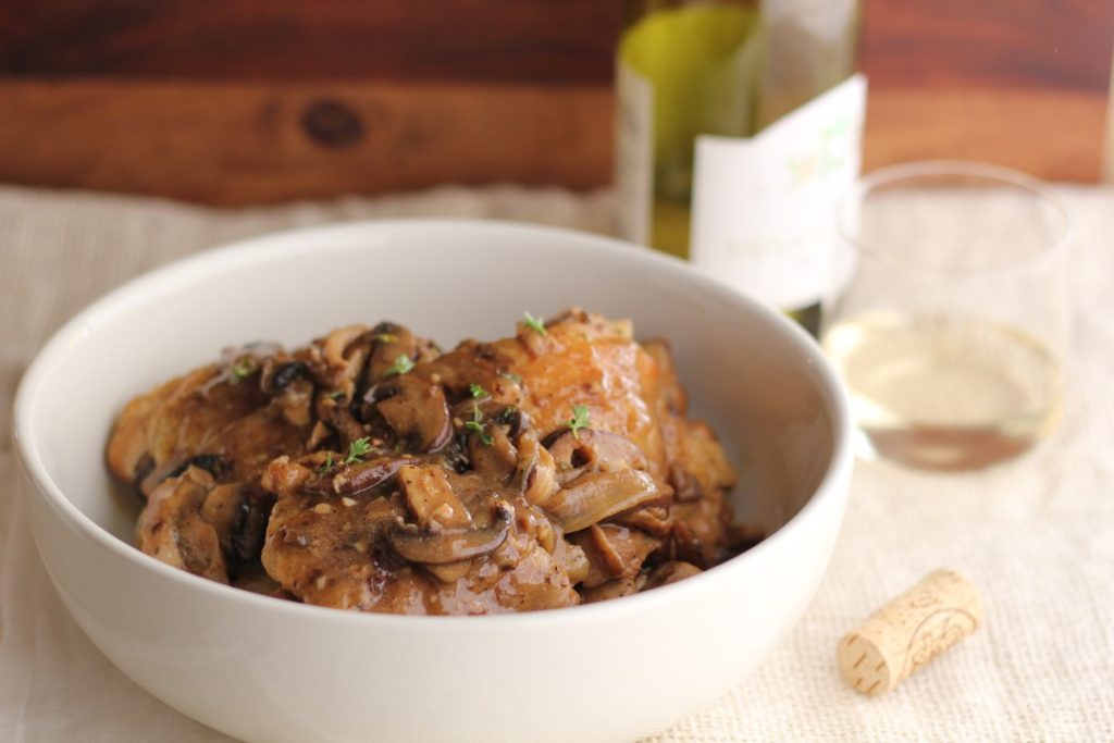 Chicken marsala with mushrooms in a white bowl