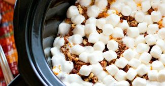 Slow cooker sweet potato casserole topped with toasted marshmallows and candied pecans