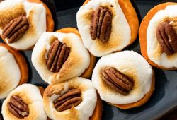 Sweet potato rounds topped with toasted marshmallows and pecan halves
