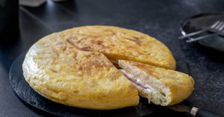 Spanish potato omelette filled with ham and cheese, sliced