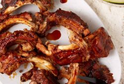 Slow cooker Coca-Cola BBQ ribs on a white platter