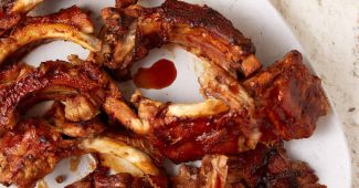 Slow cooker Coca-Cola BBQ ribs on a white platter