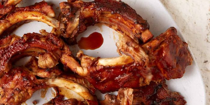 Slow cooker Coca-Cola BBQ ribs on a white platter