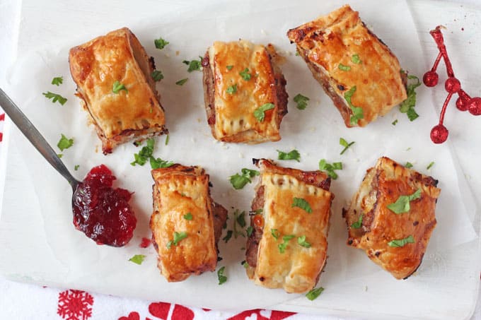 Turkey cranberry and brie puff pastry rolls with a spoon of cranberry sauce