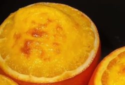 Orange pudding baked inside hollowed orange halves with a golden top