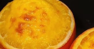 Orange pudding baked inside hollowed orange halves with a golden top