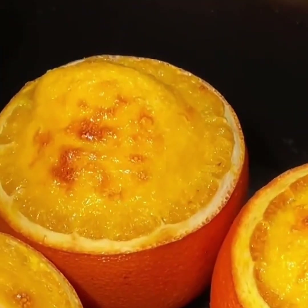 Orange pudding baked inside hollowed orange halves with a golden top