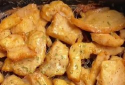Golden air fryer chicken breast bites sprinkled with chopped celery leaves