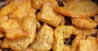 Golden air fryer chicken breast bites sprinkled with chopped celery leaves