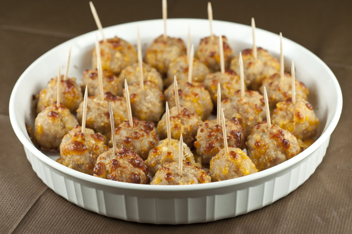 Sausage cheese balls with toothpicks in a white baking dish