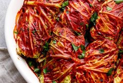 Cabbage rolls stuffed with wild rice and mushrooms in tomato sauce