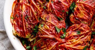Cabbage rolls stuffed with wild rice and mushrooms in tomato sauce